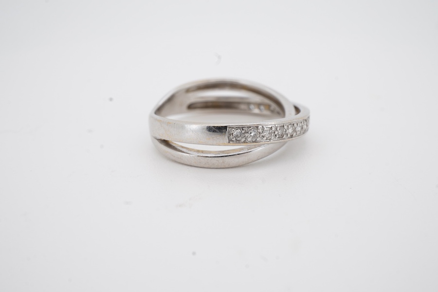A recent 18ct white gold and diamond set twin band crossover ring, size L, gross weight 3.5 grams.